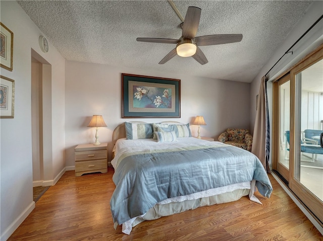 bedroom featuring access to outside, a textured ceiling, ceiling fan, and light wood-type flooring