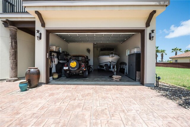 134 La Joya Prt, Aransas, TX 78373 - garage featuring decorative driveway and fence