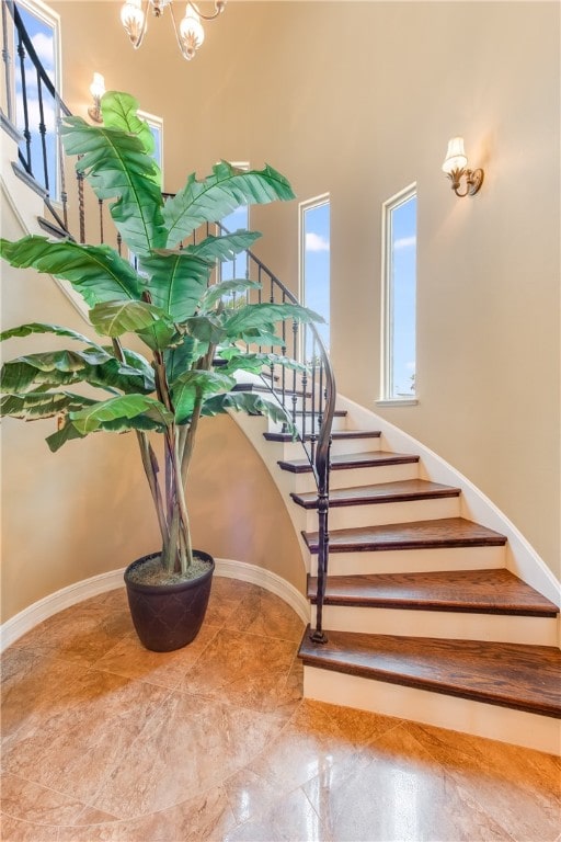 stairway featuring an inviting chandelier