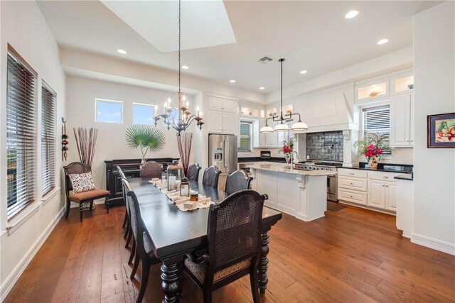 134 La Joya Prt, Aransas, TX 78373 - dining room with a chandelier, dark wood finished floors, recessed lighting, and baseboards