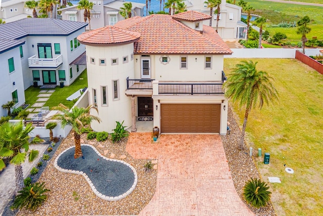 mediterranean / spanish house with a front lawn and a garage