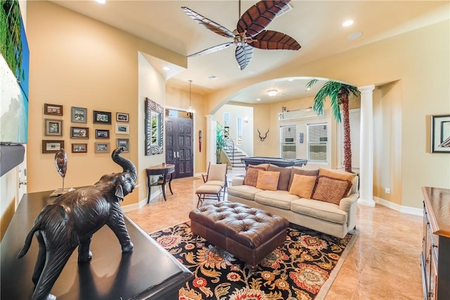 134 La Joya Prt, Aransas, TX 78373 - living room with arched walkways, ceiling fan, decorative columns, recessed lighting, and baseboards