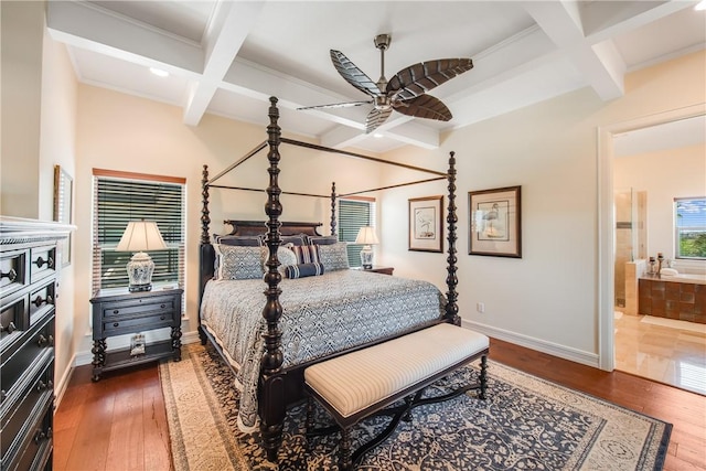 134 La Joya Prt, Aransas, TX 78373 - bedroom featuring coffered ceiling, beamed ceiling, baseboards, ensuite bathroom, and hardwood / wood-style flooring