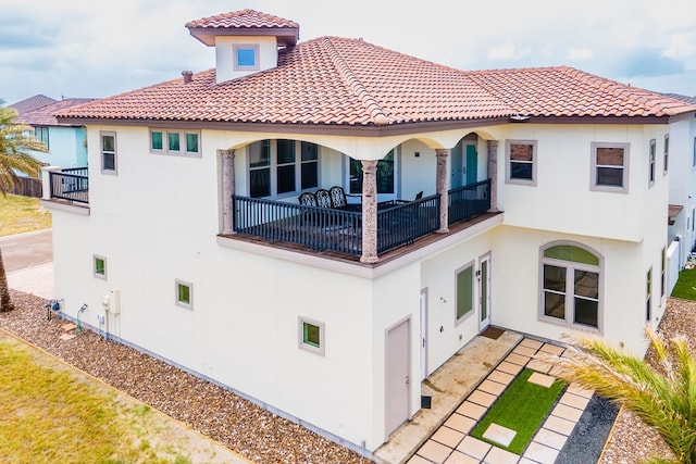 rear view of house featuring a balcony