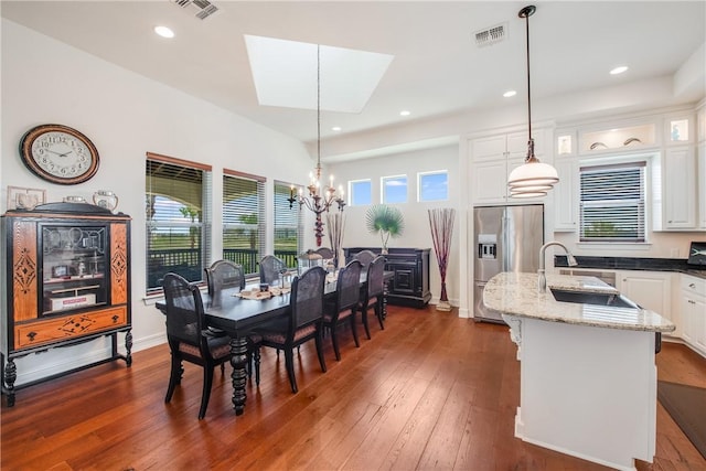 134 La Joya Prt, Aransas, TX 78373 - dining room with a skylight, a chandelier, dark wood-type flooring, plenty of natural light, and recessed lighting