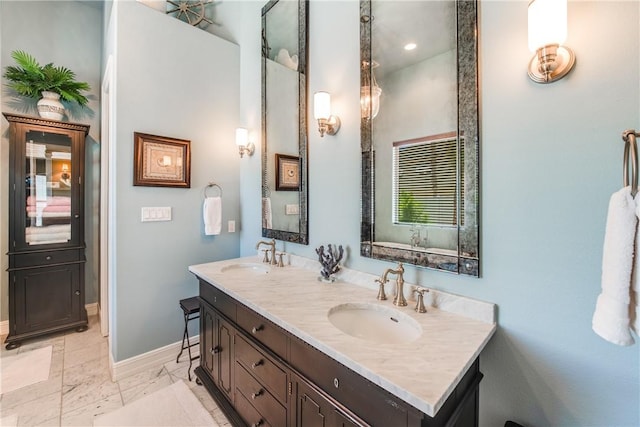 134 La Joya Prt, Aransas, TX 78373 - full bath with baseboards, marble finish flooring, and double vanity