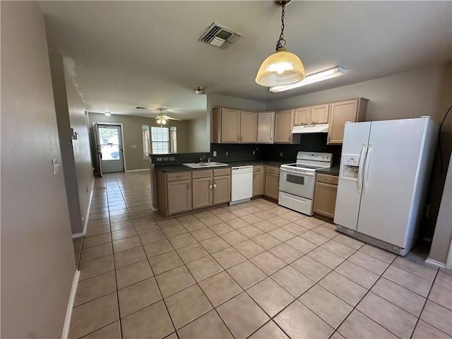 kitchen featuring dark countertops, visible vents, under cabinet range hood, white appliances, and a sink