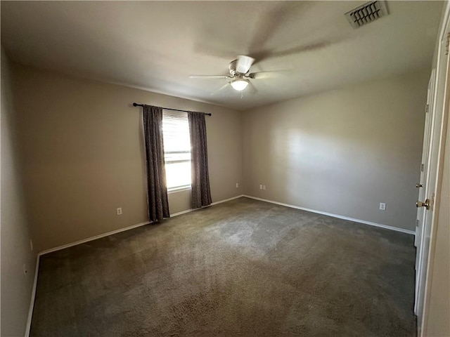 unfurnished room with baseboards, visible vents, dark colored carpet, and ceiling fan