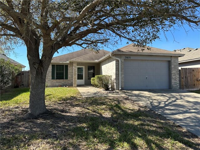 single story home featuring a front lawn and a garage