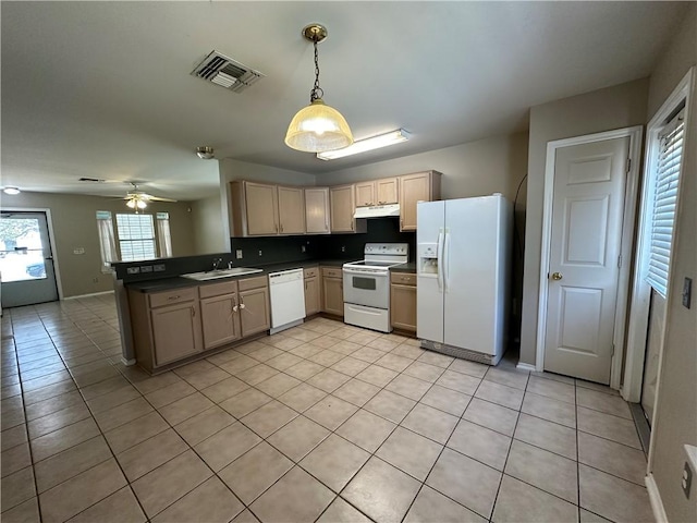 kitchen with visible vents, a sink, under cabinet range hood, white appliances, and a peninsula