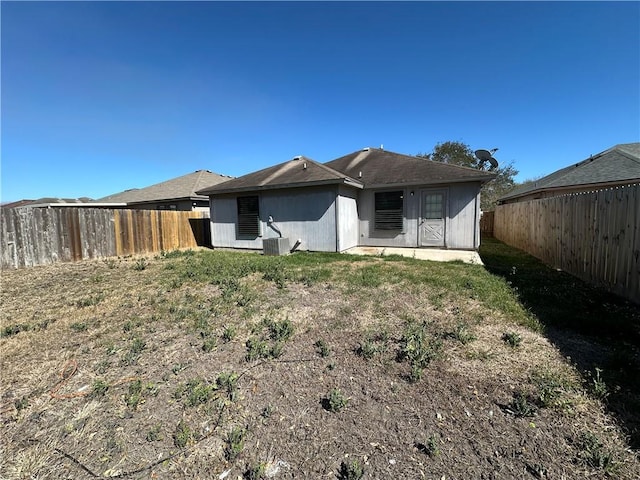 rear view of property featuring a fenced backyard