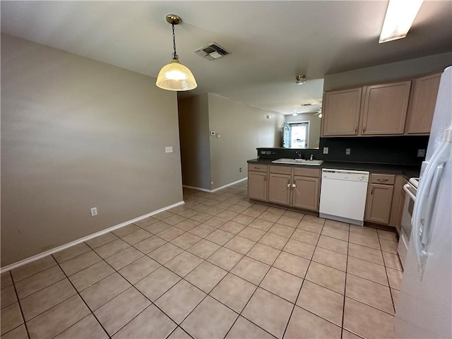 kitchen with white appliances, visible vents, a peninsula, a sink, and dark countertops