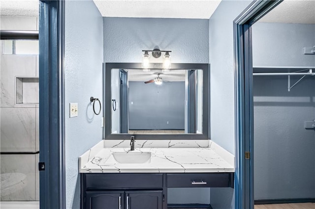 9574 Goldfinch, Corpus Christi, TX 78418 - bathroom featuring a ceiling fan, a textured wall, vanity, and a textured ceiling