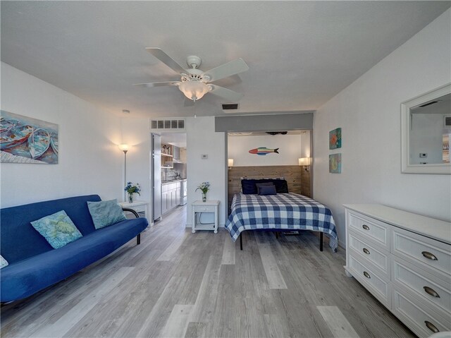 bedroom with ceiling fan and light hardwood / wood-style flooring