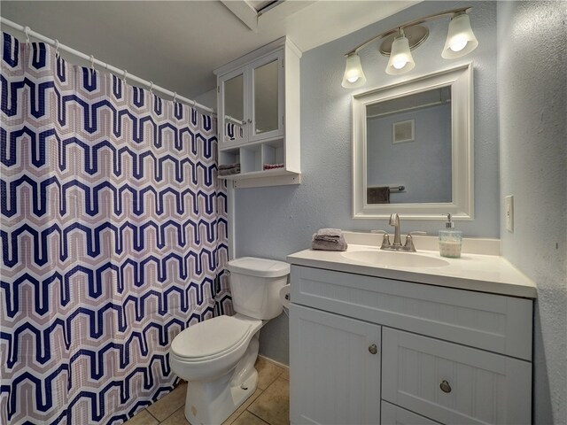 bathroom with vanity, tile patterned floors, toilet, and a shower with curtain