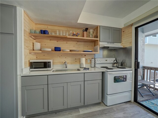 kitchen featuring gray cabinets, light hardwood / wood-style flooring, sink, and electric range