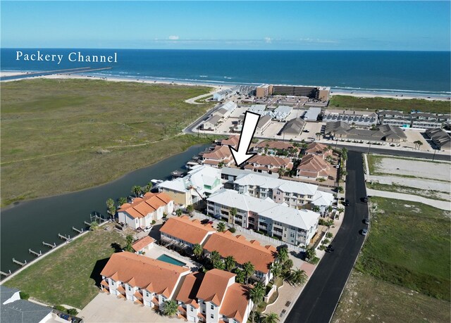 drone / aerial view featuring a view of the beach and a water view