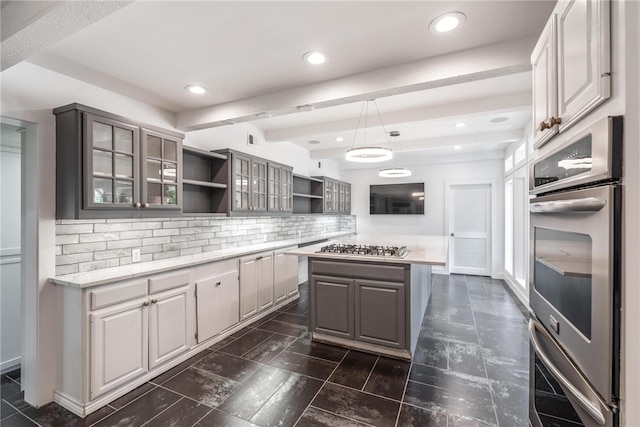 kitchen featuring gray cabinetry, tasteful backsplash, stainless steel appliances, a kitchen island, and decorative light fixtures