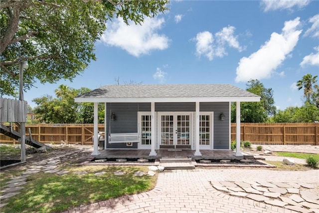 back of house featuring french doors and an outbuilding