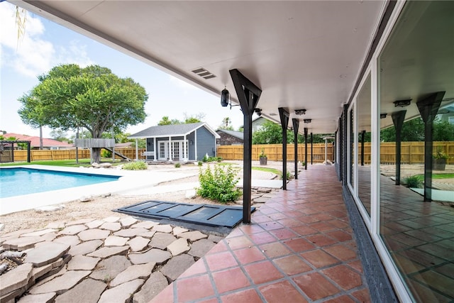 view of pool featuring an outdoor structure and a patio area