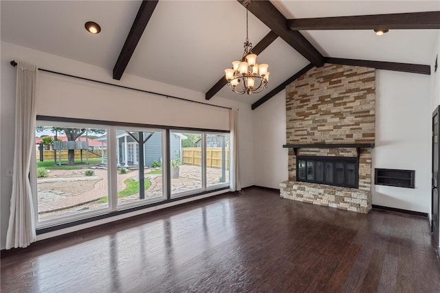 unfurnished living room featuring lofted ceiling with beams, a stone fireplace, a chandelier, and dark hardwood / wood-style floors