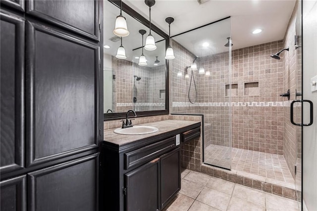 bathroom with tile patterned floors, a stall shower, vanity, and recessed lighting