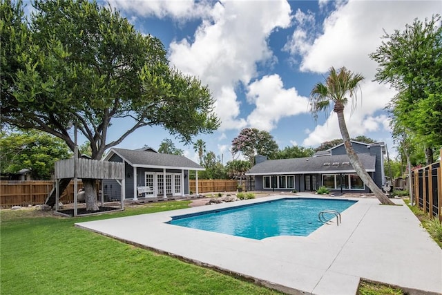 view of pool featuring an exterior structure, a patio area, an outbuilding, and french doors