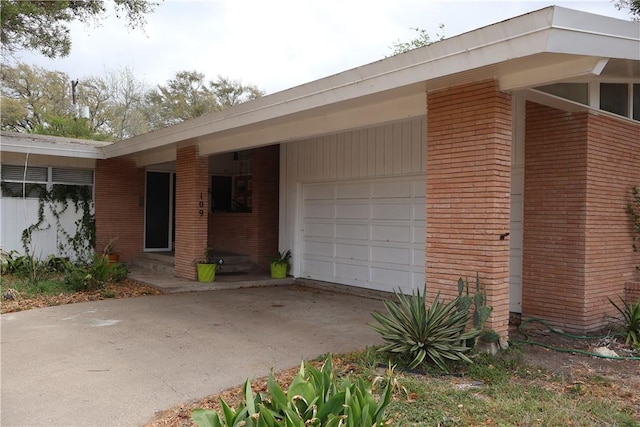109 Kissling Ave, Robstown, TX 78380 - view of home's exterior with driveway, an attached garage, and brick siding
