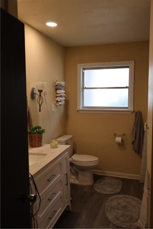 109 Kissling Ave, Robstown, TX 78380 - bathroom with toilet, vanity, baseboards, and wood finished floors
