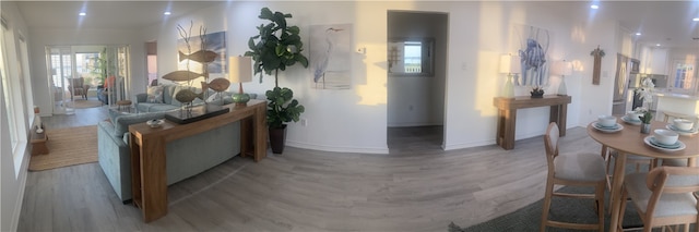 hall with wood finished floors, baseboards, and recessed lighting