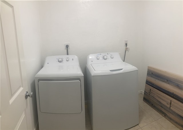 laundry area featuring separate washer and dryer and light tile patterned floors