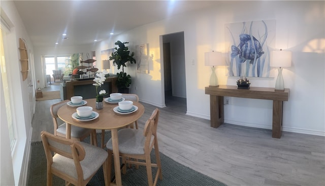 dining area with wood finished floors, baseboards, and recessed lighting