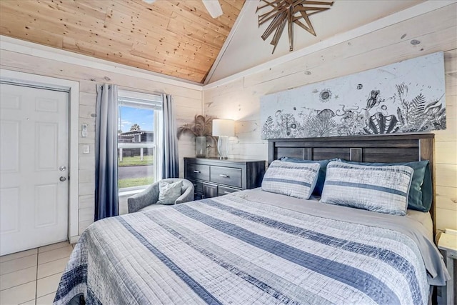 bedroom with lofted ceiling, wood ceiling, wood walls, ceiling fan, and light tile patterned floors