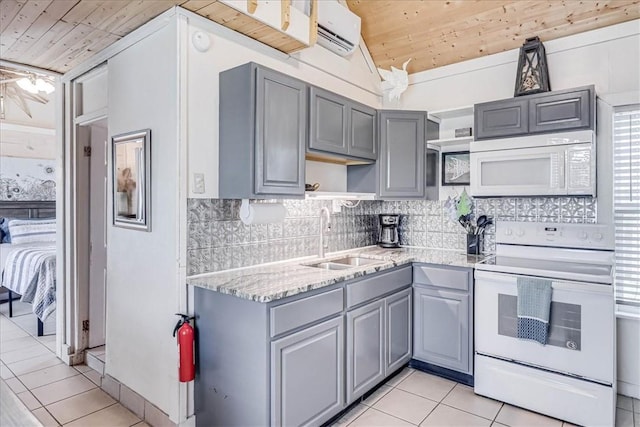 kitchen with light tile patterned floors, wood ceiling, gray cabinetry, white appliances, and sink