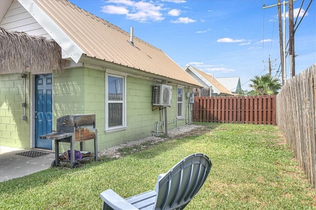 view of side of home with a lawn and ac unit