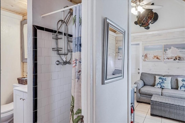 bathroom with toilet, tile patterned flooring, walk in shower, and vanity