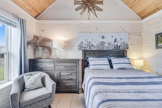 bedroom with light tile patterned floors, vaulted ceiling, wood walls, and wooden ceiling