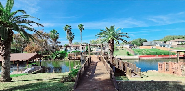 dock area with a water view, a pergola, and a yard