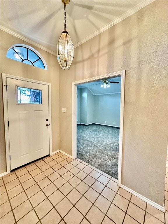 carpeted foyer featuring a notable chandelier and crown molding