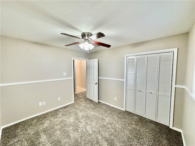 unfurnished bedroom featuring a textured ceiling, light colored carpet, ceiling fan, and a closet