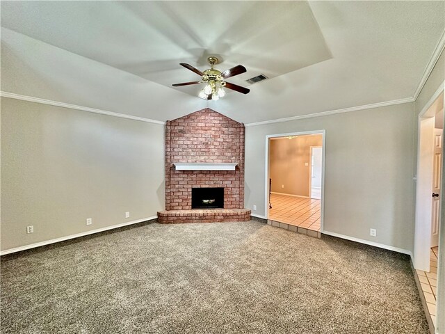 unfurnished living room featuring lofted ceiling, carpet, ceiling fan, crown molding, and a fireplace