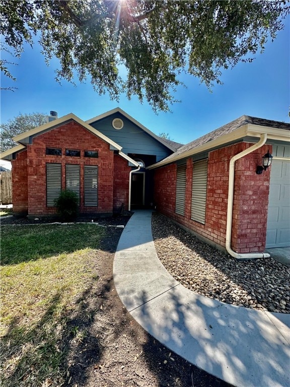 ranch-style home featuring a garage and a front lawn