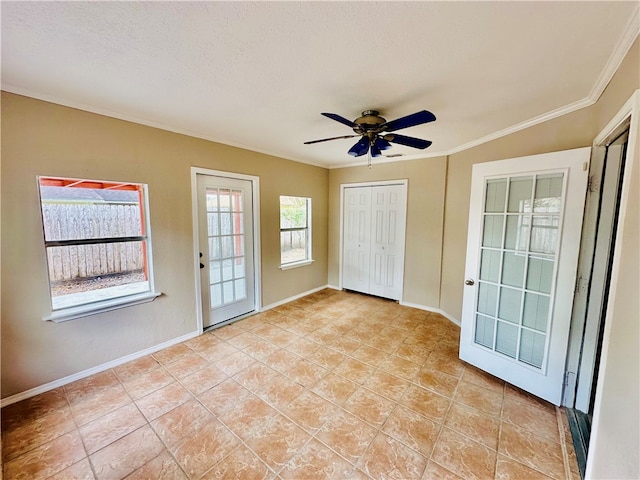 interior space with ceiling fan, a textured ceiling, light tile patterned floors, and ornamental molding