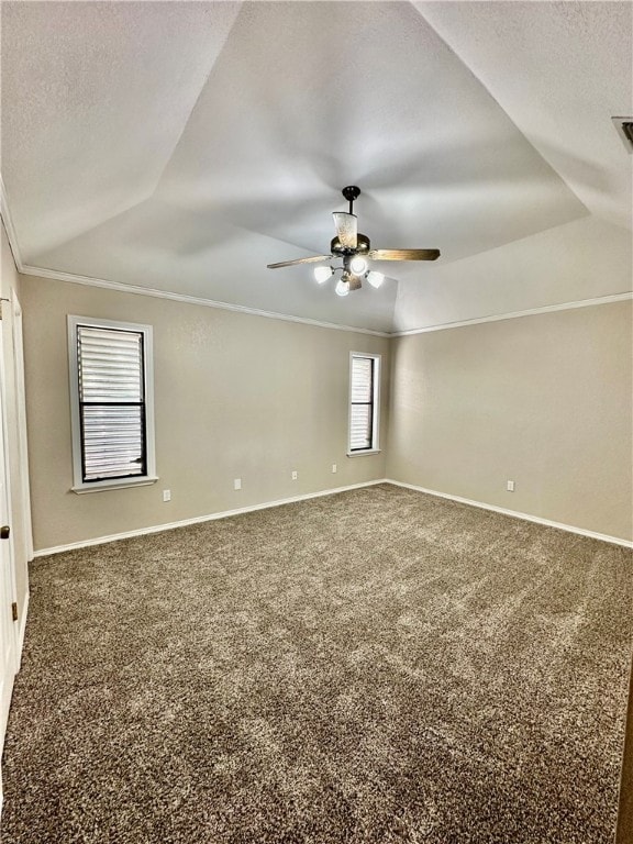 carpeted empty room with ornamental molding, a textured ceiling, ceiling fan, and vaulted ceiling