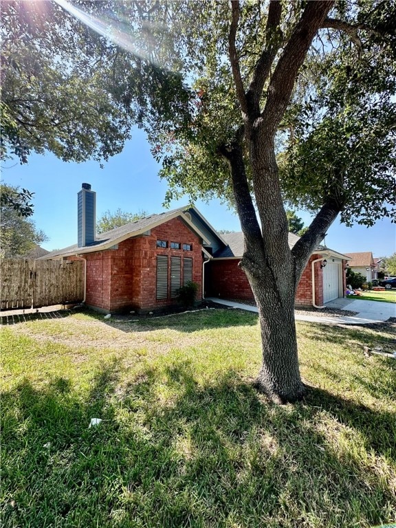 view of home's exterior with a garage and a yard