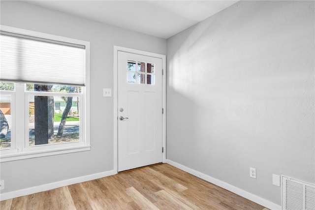 entryway featuring visible vents, baseboards, and light wood finished floors