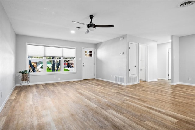 unfurnished living room featuring visible vents, baseboards, and light wood-style floors