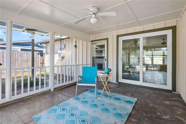 sunroom / solarium with a ceiling fan and a wealth of natural light