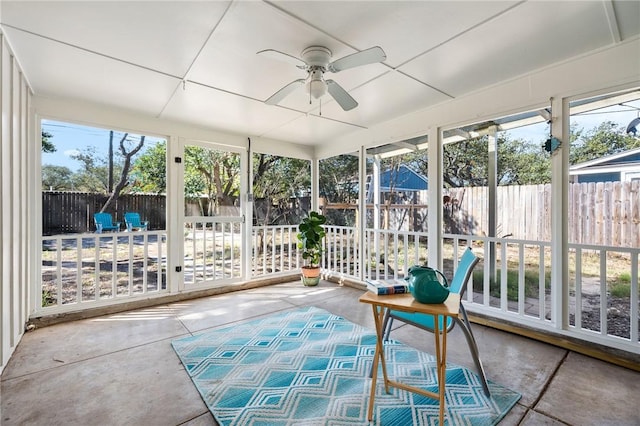 unfurnished sunroom with a healthy amount of sunlight and a ceiling fan