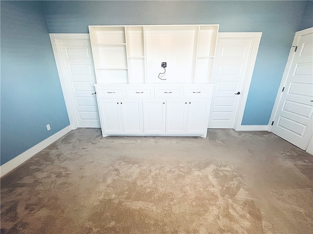 unfurnished bedroom featuring a closet and light colored carpet